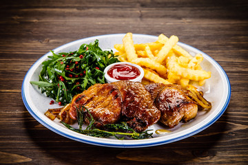 Grilled beefsteak with french fries and vegetable salad