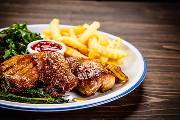 Grilled beefsteak with french fries and vegetable salad