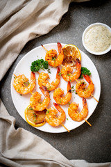 Grilled tiger shrimps skewers with lemon