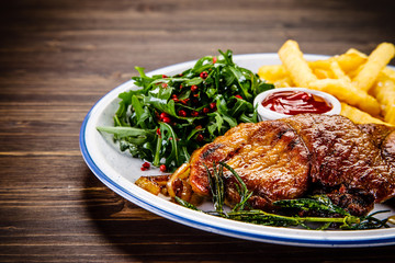 Grilled beefsteak with french fries and vegetable salad