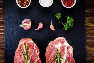 Raw pork on black stone