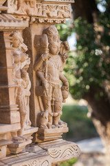 The four-hands embodiment of god Vishnu executed in a stone in the form of a bas-relief on a wall of one of temples in Khajuraho.