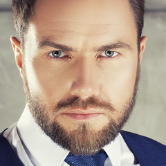 Close-up face of handsome man with beard and blue eyes