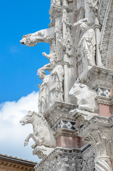 Gargoyles and Saints on the facade of the cathedral of Siena