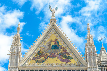 A close-up of the upper facade mosaic of the cathedral of Siena representing the coronation of the Virgin Mary