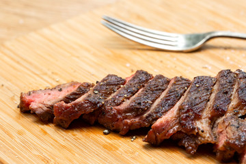 Well done beef steak is sliced into pieces and ready to be served for family's dinner. It looks great with delicious taste.