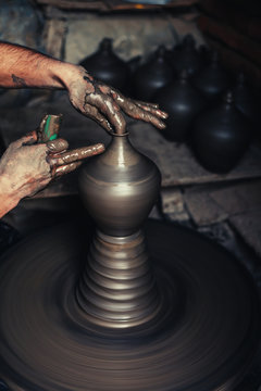 potter hands doing clay bowl on wheel
