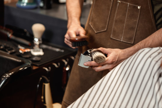 Barber and bearded man in barber shop