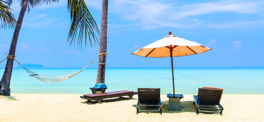 Amazing view of beautiful beach with palm trees, chaises and transparent turquoise water. A great...