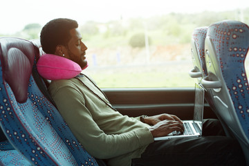 Portrait of working man using laptop computer in bus travel - obrazy, fototapety, plakaty