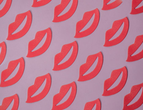 Red female lips pattern on pink background