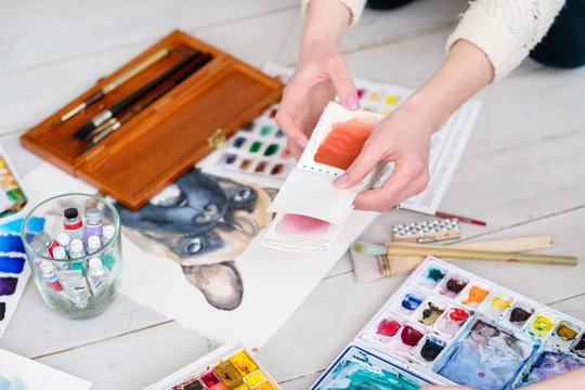 artist instruments and tools for creative leisure. watercolors brushes and color swatches. painting hobby