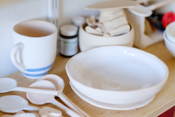 Obraz na płótnie Canvas handmade crockery. handicraft pottery workshop. artisan clay plates bowls cups and mugs assortment