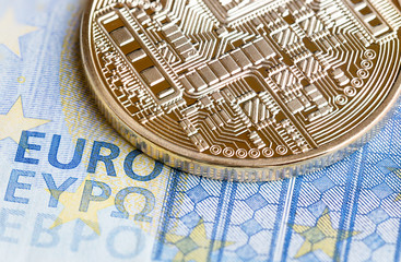 Fototapeta na wymiar Bitcoin Cryptocurrency is Digital payment money Concept, Gold coins with electronic circuit on EURO EYP20 bill.Cryptocurrency can uses designed work as medium of exchange in network