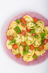 Filled tortellini with herbs, tomatoes