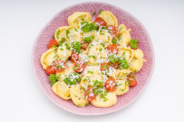 Filled tortellini with herbs, tomatoes