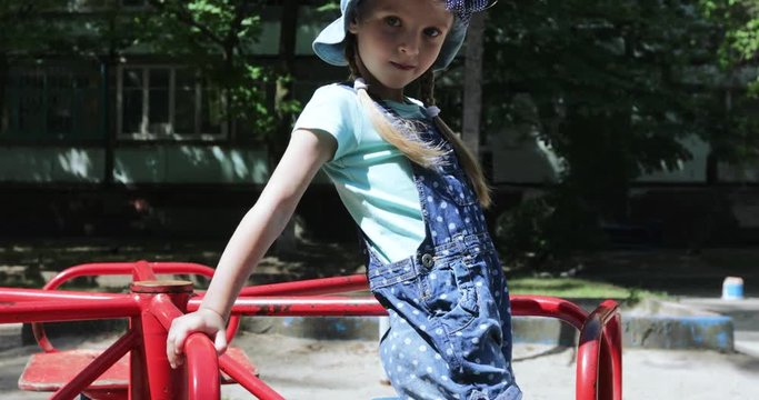 Girl child on carousel