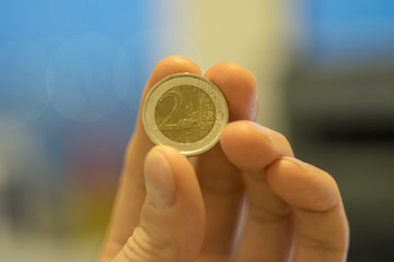 coin two euros in hand, close-up