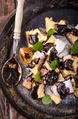 Cutted pancakes, Kaiserschmarrn delish dessert with plums