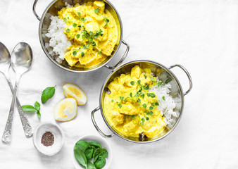 Chicken coconut milk curry sauce with rice on a light background, top view. Indian style food