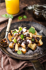 Cutted pancakes, Kaiserschmarrn delish dessert with plums