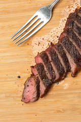 Well done beef steak is sliced into pieces and ready to be served for family's dinner. It looks great with delicious taste.