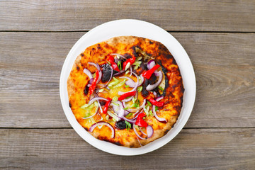 Traditional Italian focaccia with onion and bell pepper, homemade flat bread. Homemade family cooking, tasty appetizer flat lay at old table