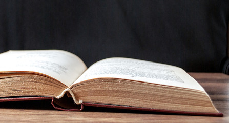 unfolded book on a black background