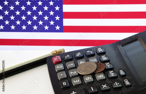 Coin Of United Stage America On Calculator And Pencil White Coin Of United Stage America On Calculator And Pencil White Floor With Usa Flag