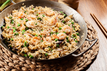 Fried rice with shrimp and vegetables on a frying pan