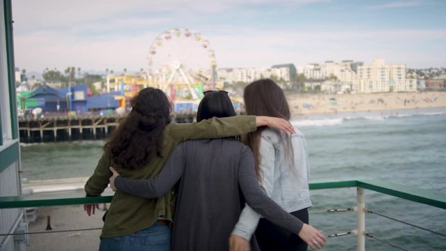 Group Of Girlfriends Put Their Arms Around Each Other And Enjoy View Of Santa Monica Pier (Shot On Red Scarlet-W Dragon In 4K, Slow Motion)