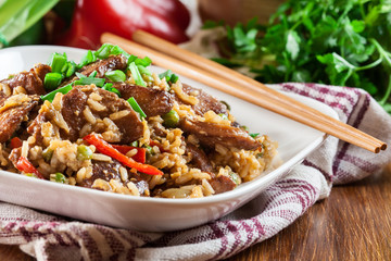 Fried rice with chicken and vegetables served on a plate