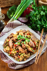 Fried rice with chicken and vegetables served on a plate