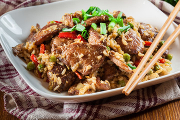 Fried rice with chicken and vegetables served on a plate