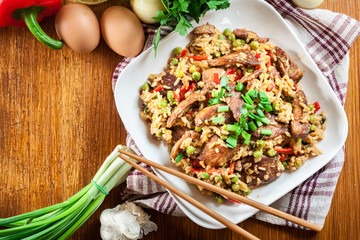Fried rice with chicken and vegetables served on a plate