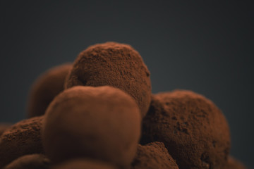 craft chocolate truffles on wooden board with cocoa powder