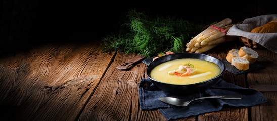delicious asparagus cream soup with prawns and fresh dill