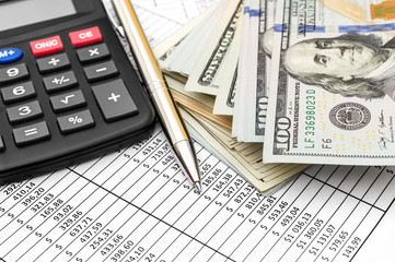 Pen, calculator and money on document with financial data.