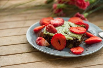 Cake with strawberry on plate.
