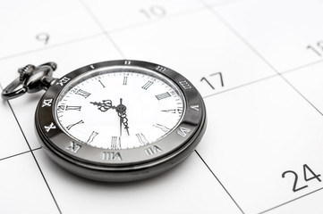 Pocket watch on the calendar.