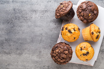 Homemade chocolate muffins on the vintage background.