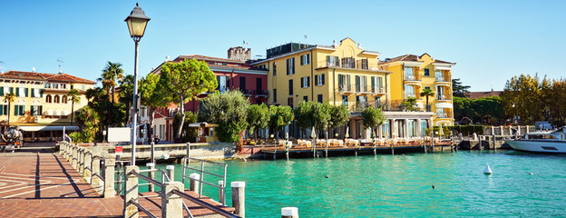 Bridge embankment yacht pier Lake Garda restaurants hotels luxur - obrazy, fototapety, plakaty