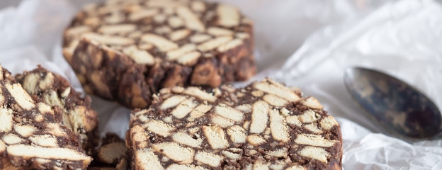 Pieces of chocolate cake from cookies and cocoa with marshmallow on bakery paper