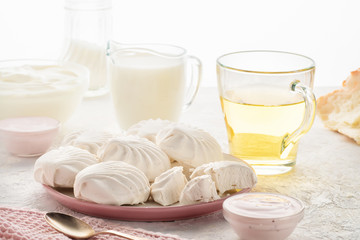 Protein products ingredients for breakfast marshmallows sour cream yogurt milk piece of bread green tea