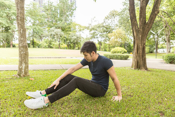 A young sportsman getting ready for athletic and fitness training outdoors. Healthy lifestyle concept with sunrise early morning.