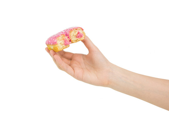 Hold Handing Delicious Pink Bitten Donut With Pink Cream Inside. Isolated