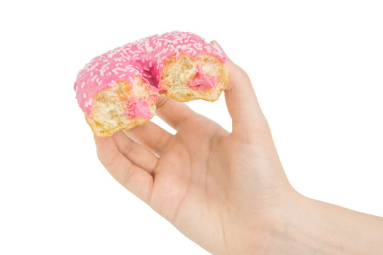 Hold Handing Delicious Pink Bitten Donut With Pink Cream Inside. Isolated