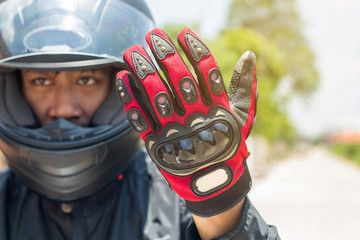 Man in a Motorcycle with helmet and gloves is an important protective clothing for motorcycling...
