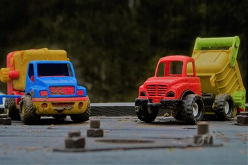 Obraz na płótnie Canvas Two colorful toy trucks