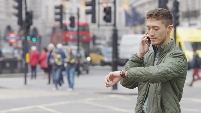 Attractive mixed race man using his phone outdoors in the city